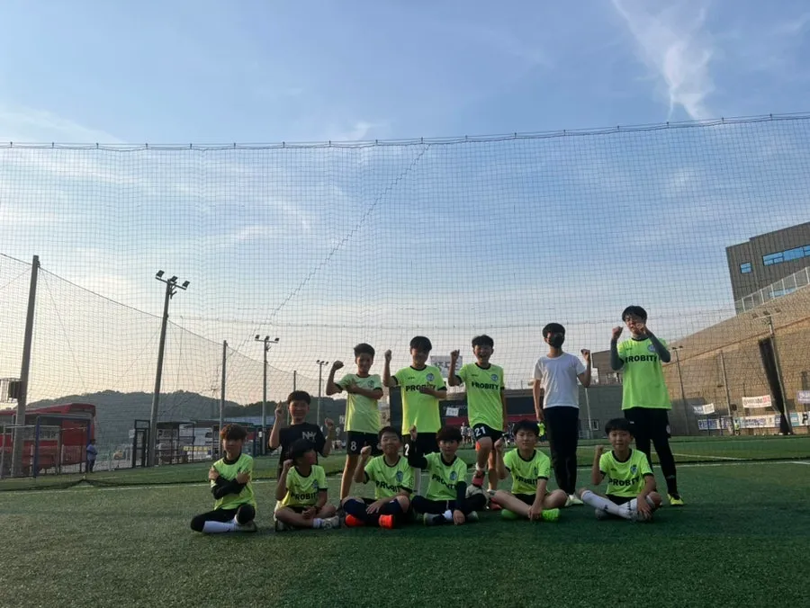 FC Probity players gathered together on the pitch after training